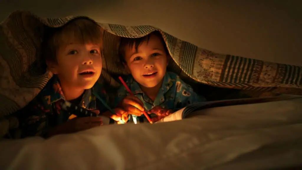 Two boys playing flashlight