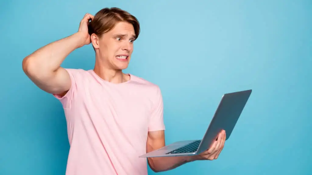 man confused shocked looking at his computer