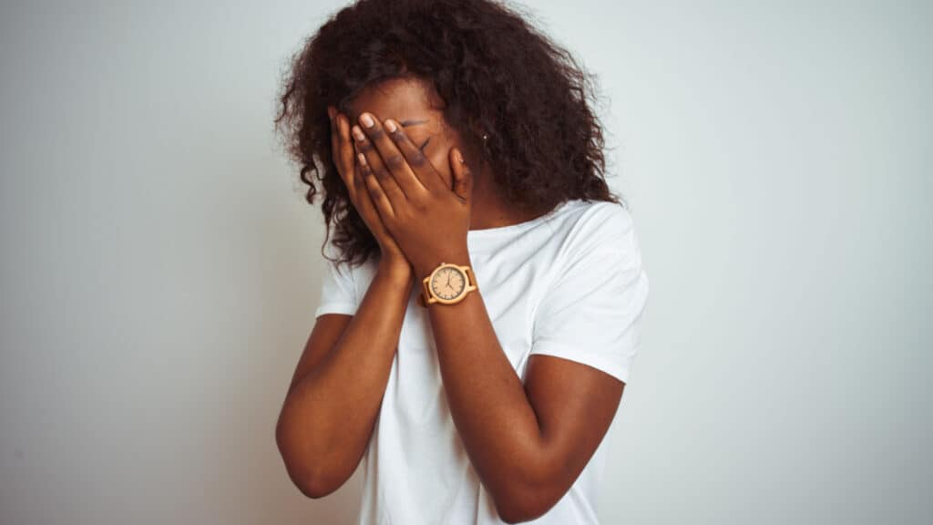 woman feeling sad hands in face