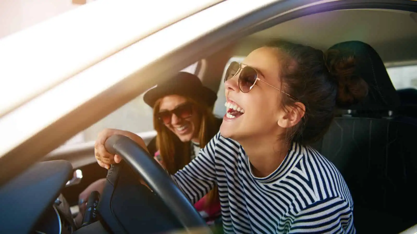 women laughing in the car