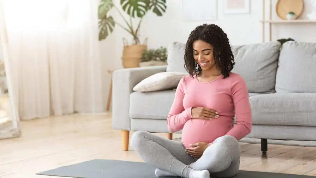 pregnant woman exercise yoga breathing happy