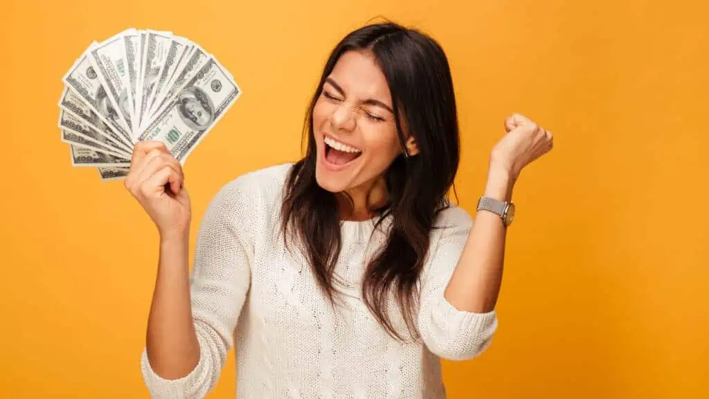 happy woman holding money and celebrating