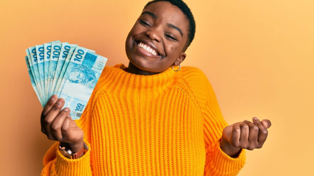 happy woman holding money smiling