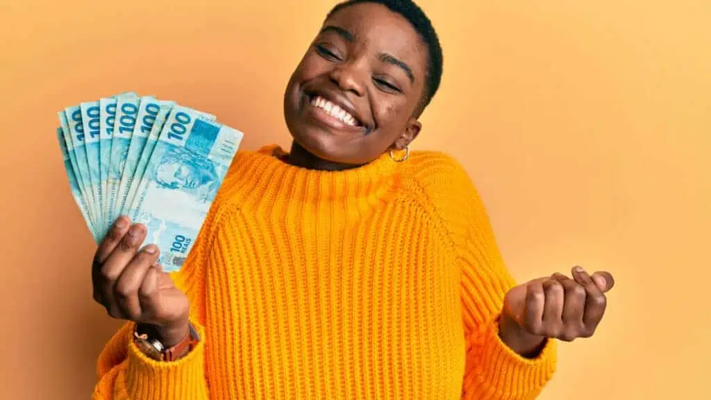 happy woman holding money smiling