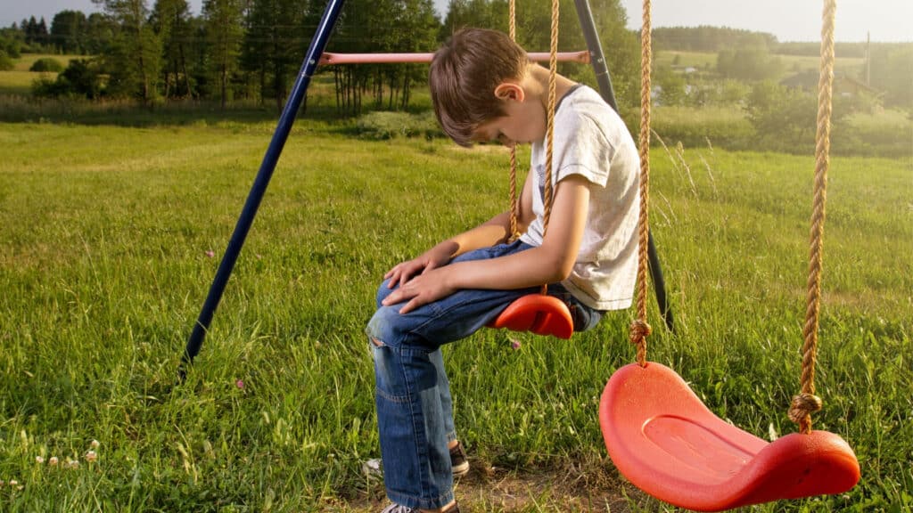 sad boy on the swings kids