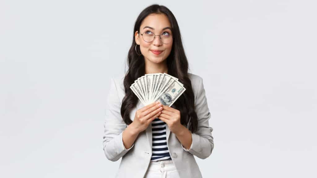 woman holding money and happy