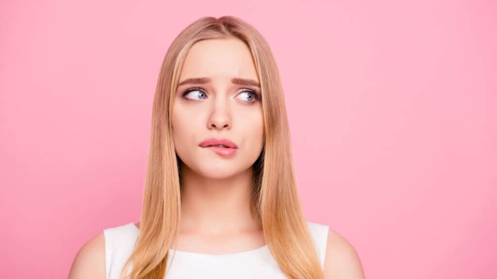 worried sad woman biting her lip