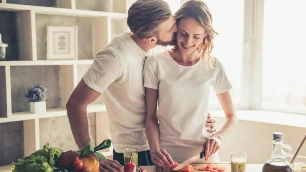 happy couple smiling in the kitchen