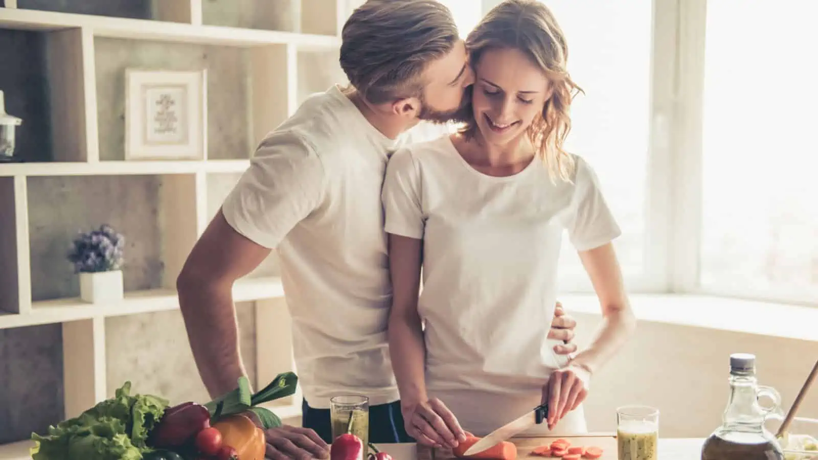 happy couple smiling in the kitchen