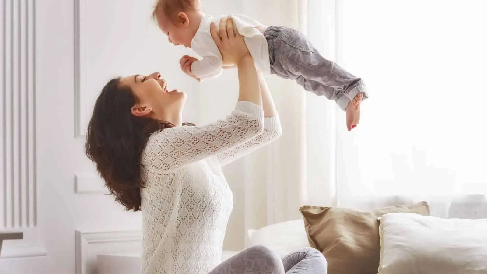 happy mom and baby laughing