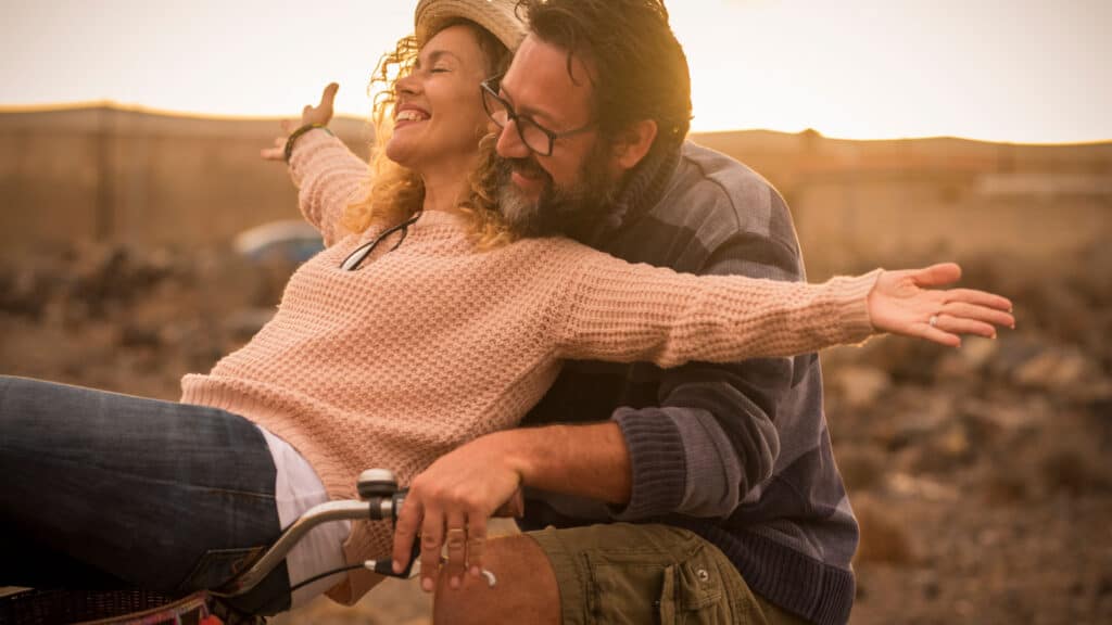 happy couple smiling on bike