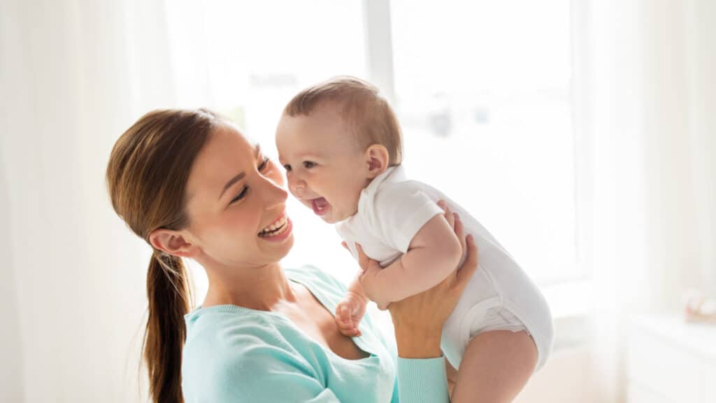 mom and baby smiling and laughing happy