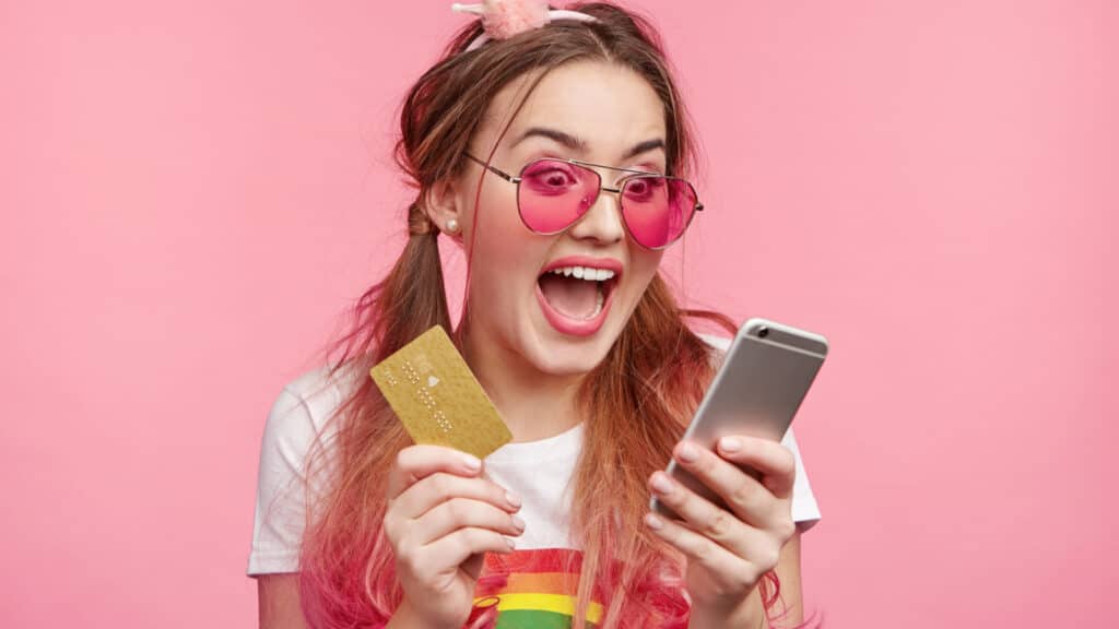 woman spending money on her credit car phone happy hippie