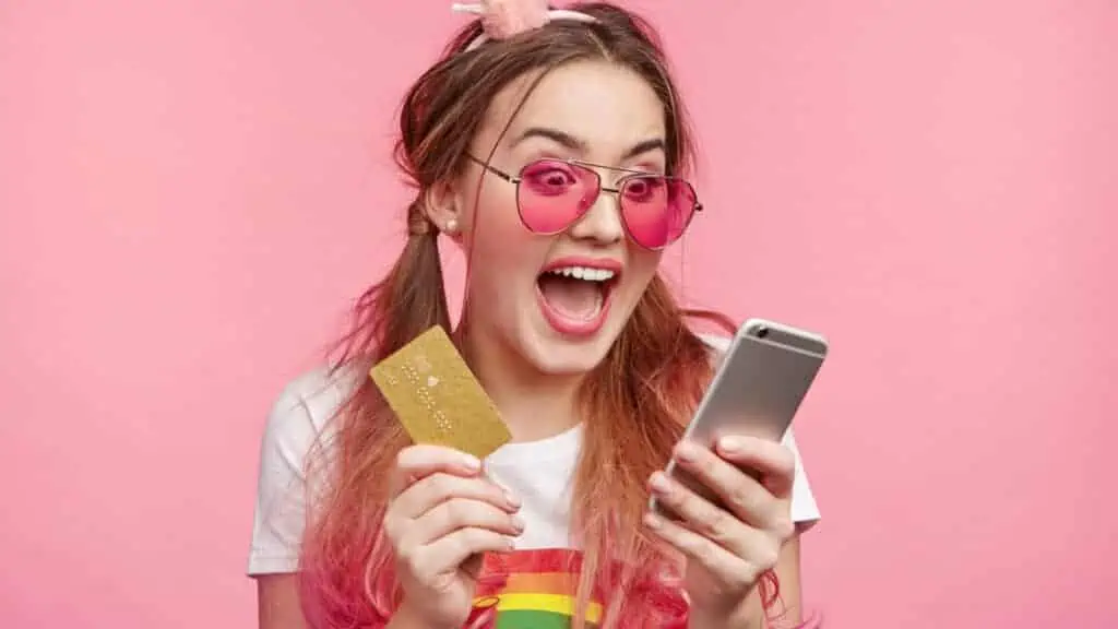 woman spending money on her credit card phone happy hippie