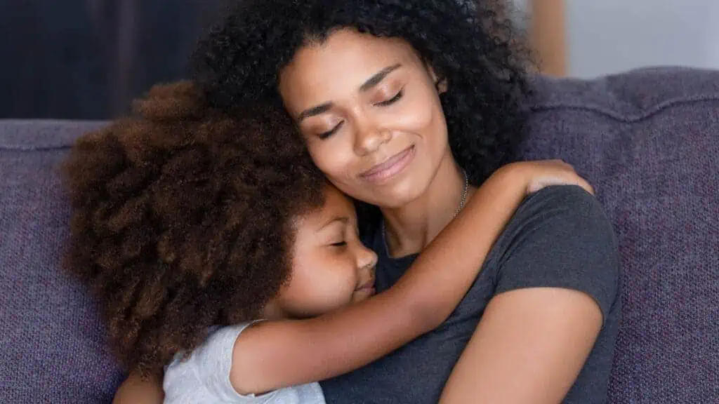 mom and daughter hugging