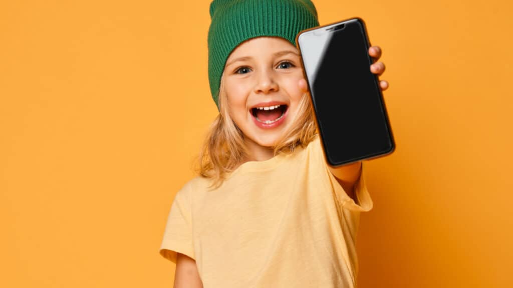 smiling girl holding a phone kid