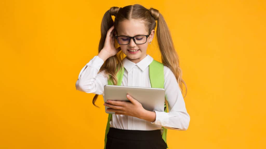 school girl glasses piggy tails tablet confused thinking