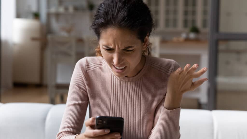 woman shocked at her phone mad