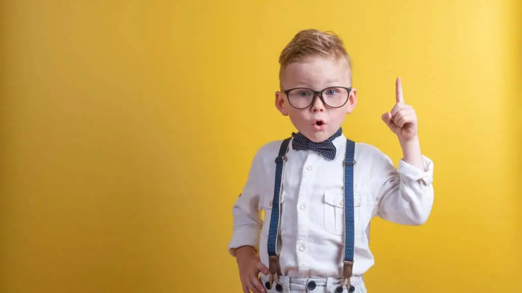 cute smart boy with suspenders glasses bow this shocked