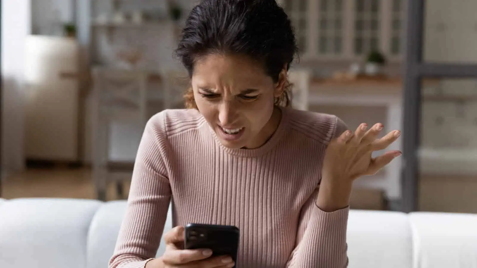 woman shocked at her phone mad