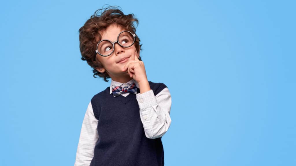 little boy in glasses smart thinking