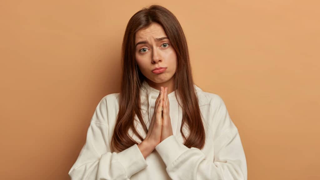 woman sad sorry praying