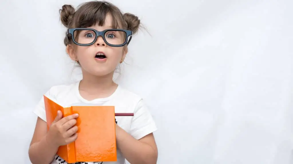 cute girl with glasses and a book reading piggy buns surprised shocked