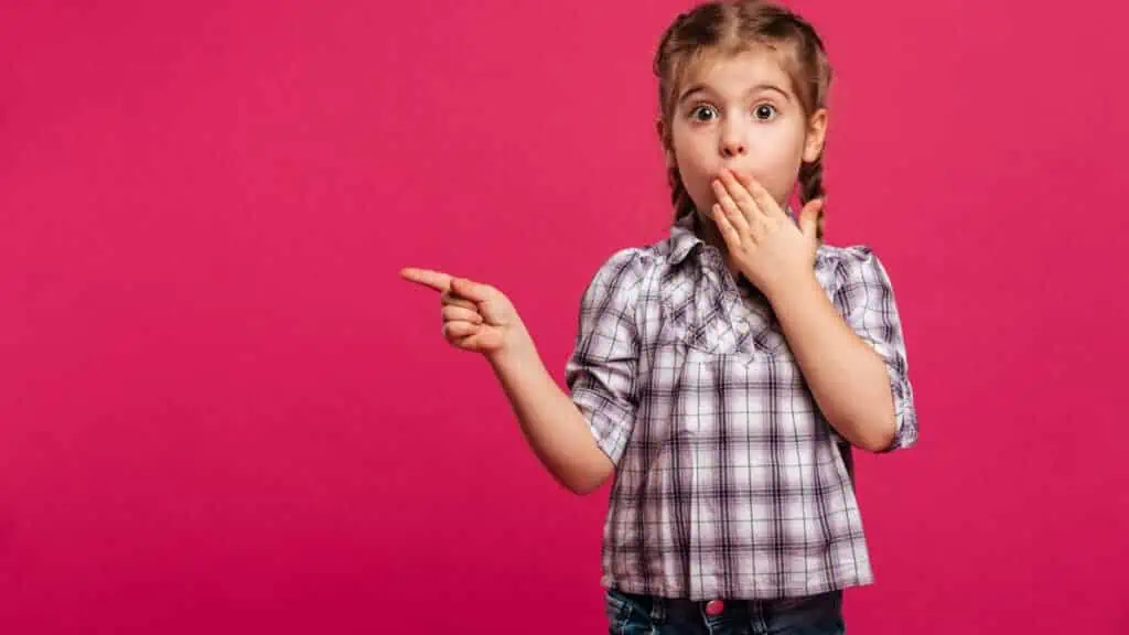 shocked girl pointing in pink