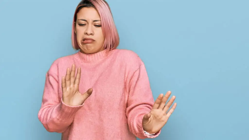 disgusted woman in pink with grossed out face