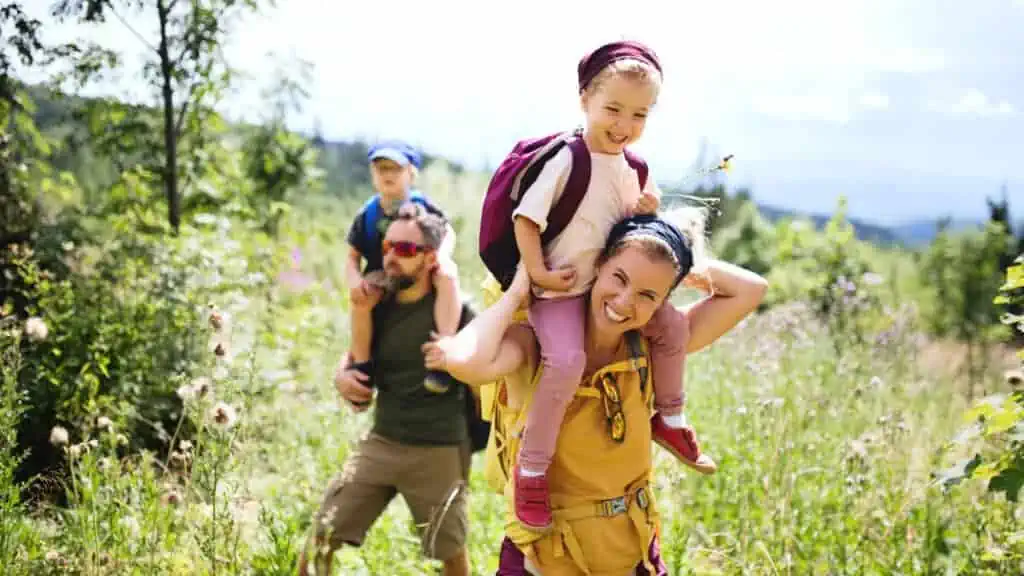 happy family of four going for a hike in nature