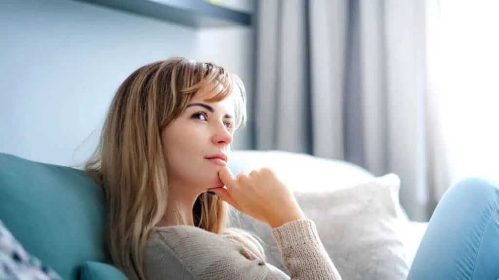 woman thinking on couch