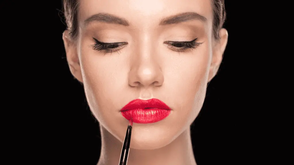 woman doing her makeup lipstick