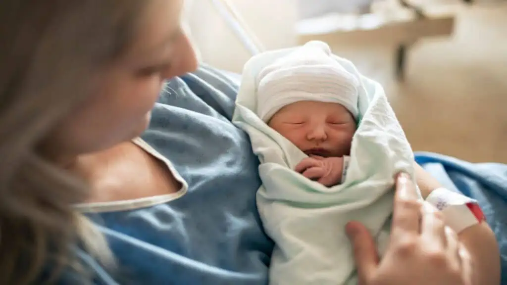 postpartum mom with newborn baby in the hospital