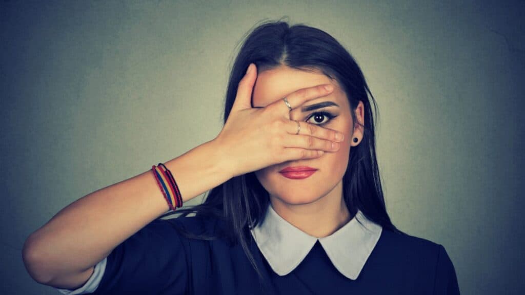 woman hiding avoiding hand on face