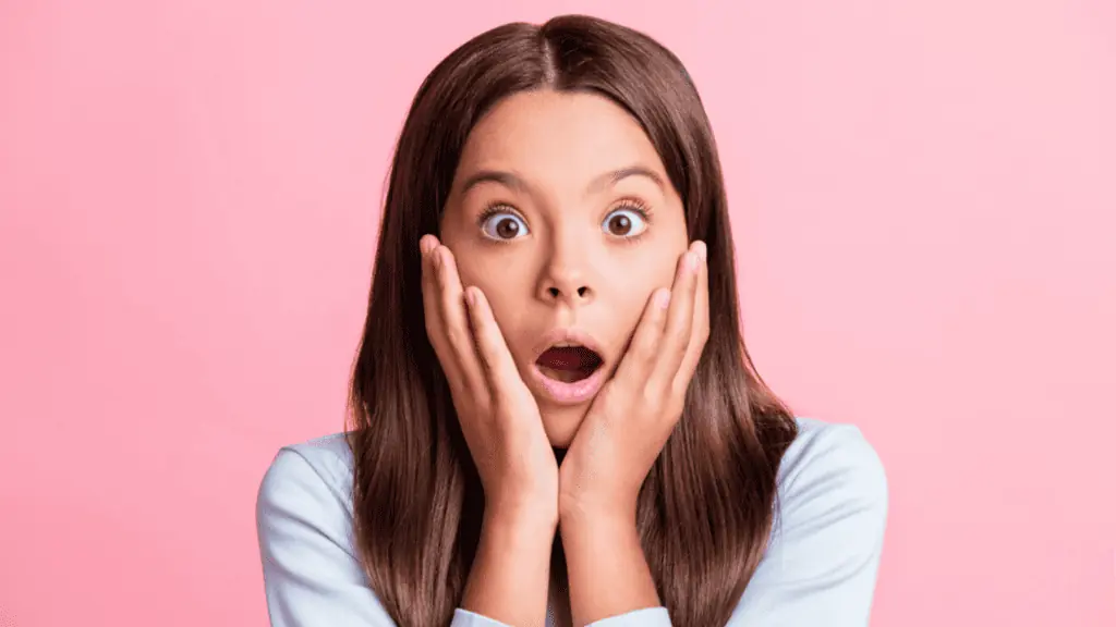 Surprised girl with pink background