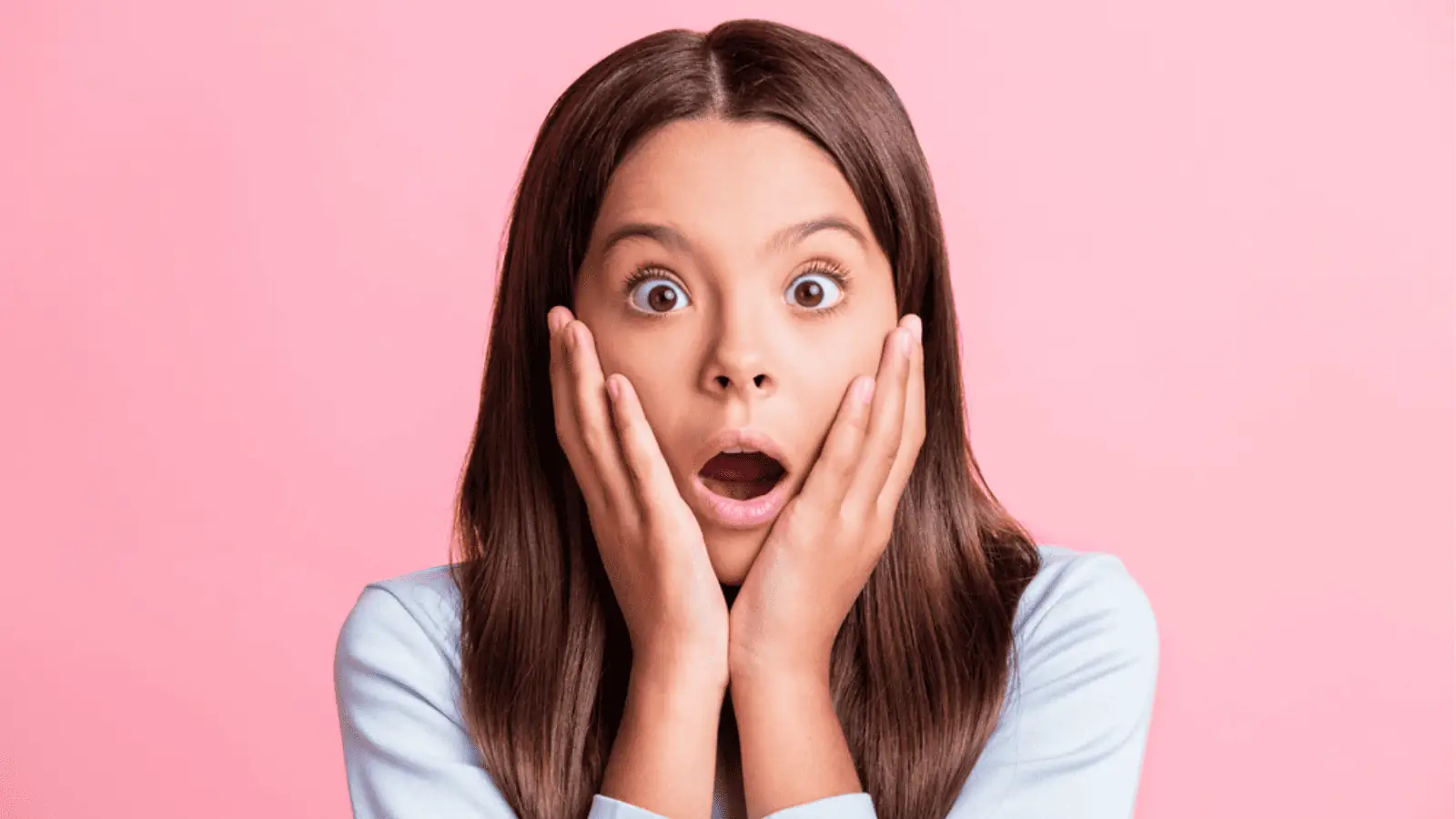 Surprised girl with pink background