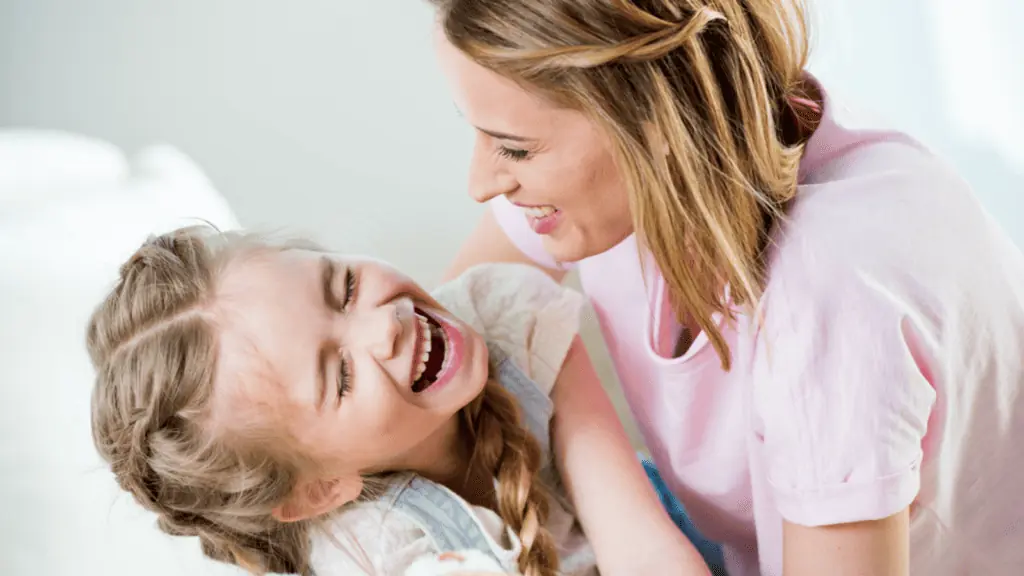 happy mom and girl laughing joke giggle love