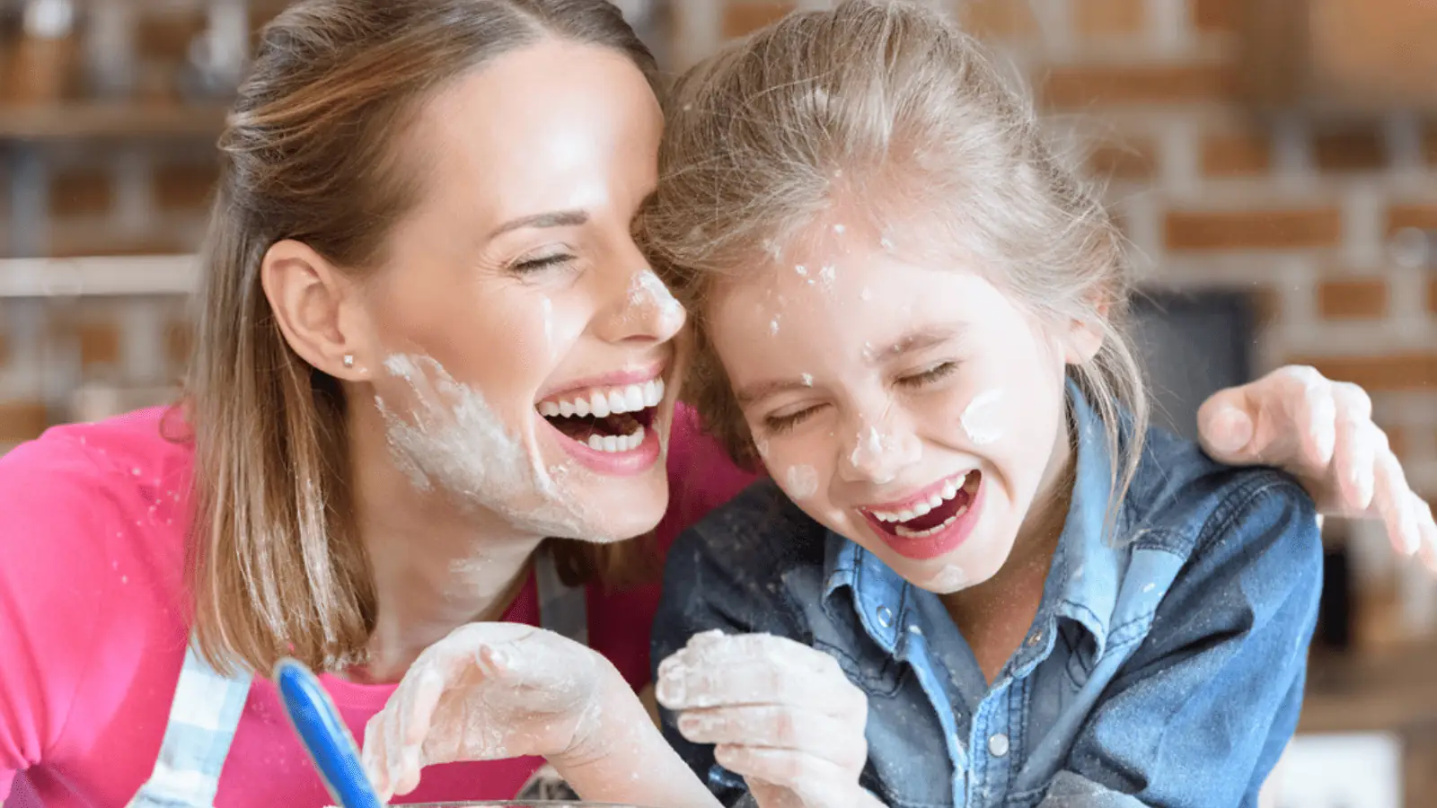 mom and daughter laughing cooking having fun