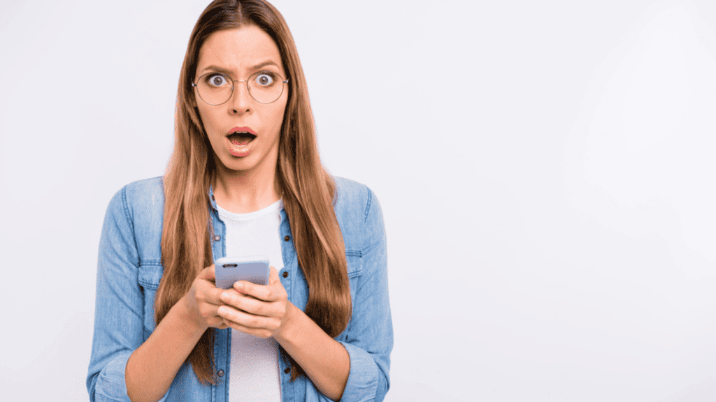 shocked woman phone glasses