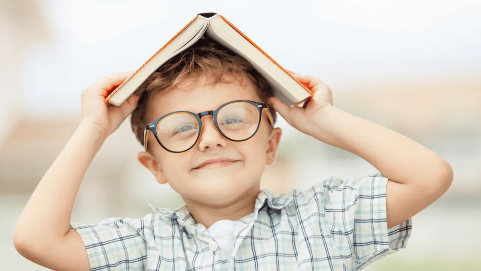 little boy in glasses reading