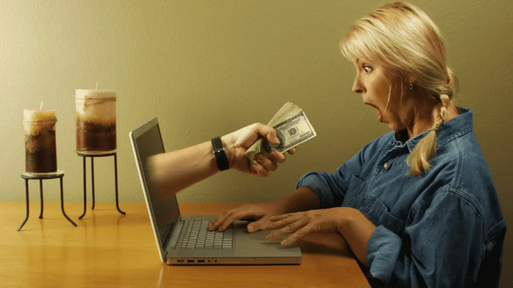 woman getting money from her computer scam shock