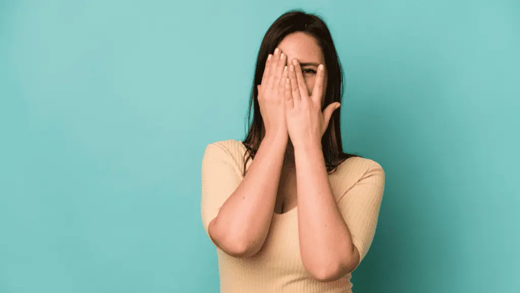 embarrassed mom hiding behind her face