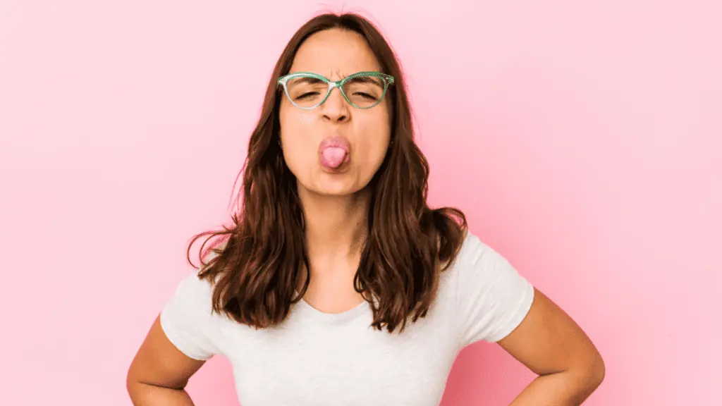 girl sticking out her tongue glasses frustrated tease