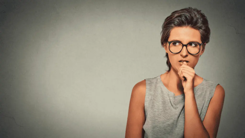 nervous anxious woman glasses biting nails