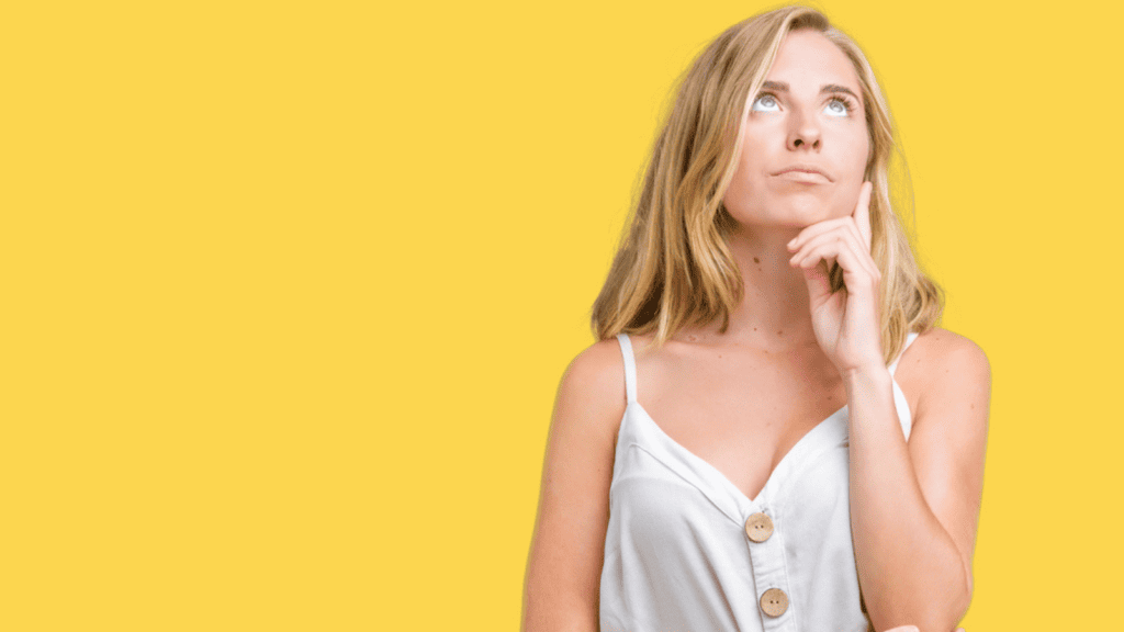 woman thinking finger on face yellow