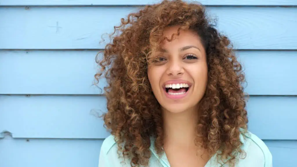 happy smiling woman curly hair