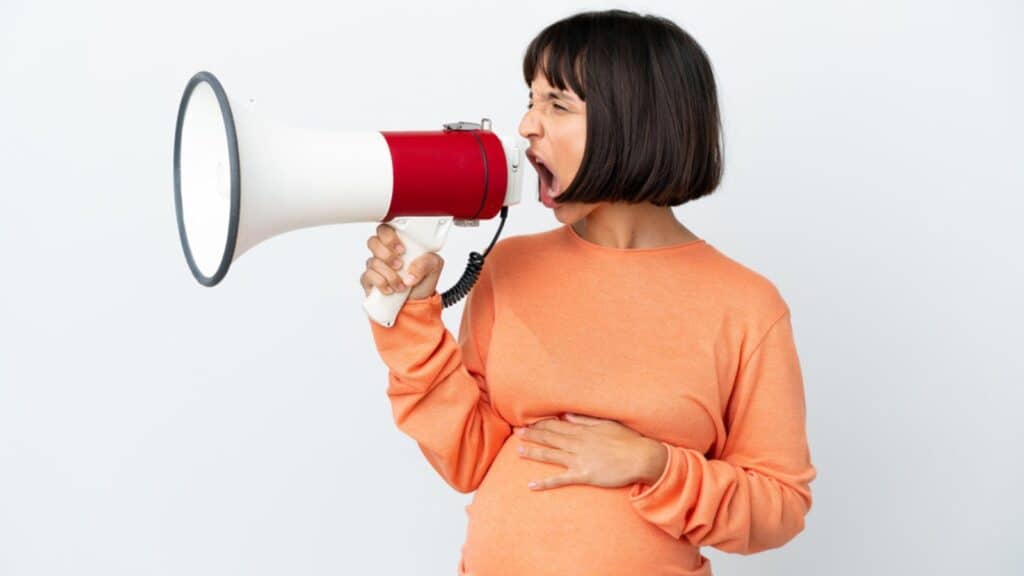 pregnant woman with a megaphone pregnancy announcement yelling mad