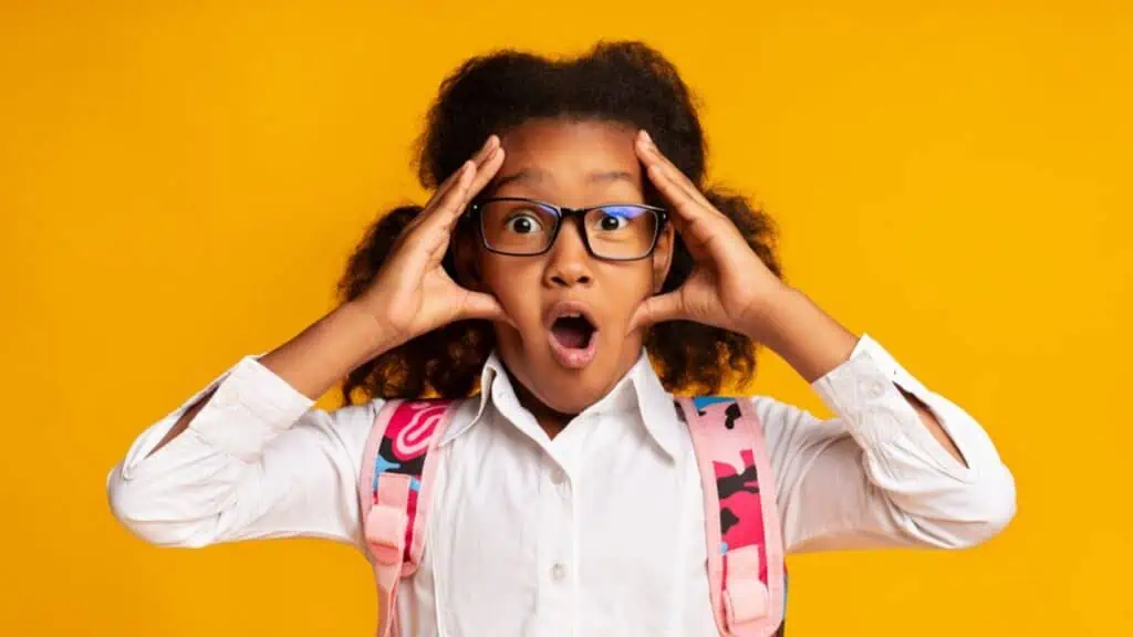 shocked little girl hands on head