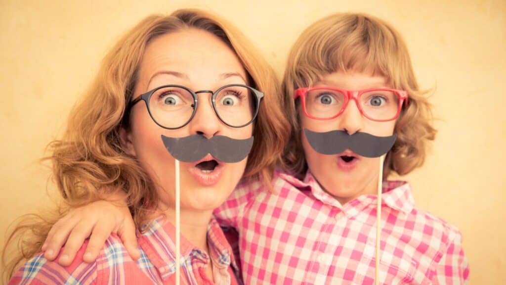 funny mom and daugther girl with mustaches and glasses