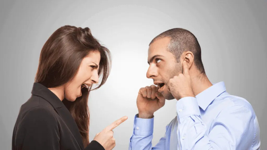 annoyed woman annoying man plugging his ears yelling couple